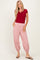 woman wearing a red short sleeve henley top and red and white striped tapered pants with pockets