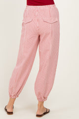 woman wearing red and white striped loose-fitting pants with elastic cuffs and back pockets