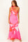 woman wearing a pink floral one-shoulder maxi dress with a fitted silhouette and a matching choker necklace