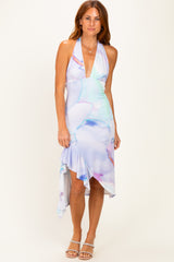 woman wearing a multicolored halter neck midi dress with a ruffled hem and a plunging neckline