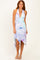 woman wearing a multicolored halter neck midi dress with a ruffled hem and a plunging neckline