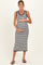 woman wearing a navy and white striped maternity dress, holding her baby bump with a smile