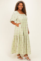 woman wearing a light green floral print maxi dress with puff sleeves and pockets