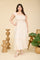 woman wearing a cream and beige striped plus size maxi dress with ruffled sleeves and a smocked bodice