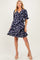 woman wearing a navy floral wrap dress with ruffled sleeves, showcasing her baby bump