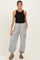 woman wearing a black tank top and gray maternity jogger pants with pockets, standing and smiling