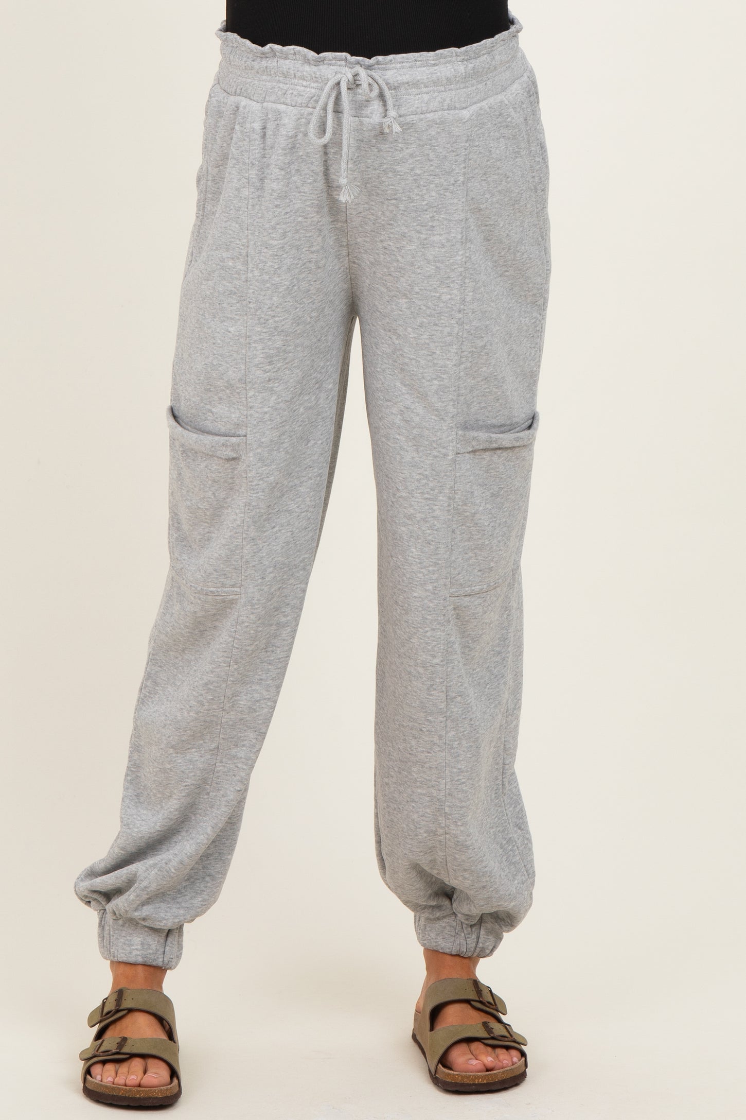 woman wearing light gray maternity sweatpants with drawstring waist and side pockets