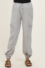 woman wearing light gray maternity sweatpants with drawstring waist and side pockets