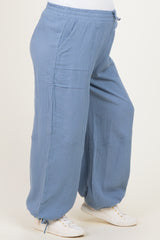maternity wear light blue loose-fitting pants with a drawstring waist and side pockets, model showcasing baby bump