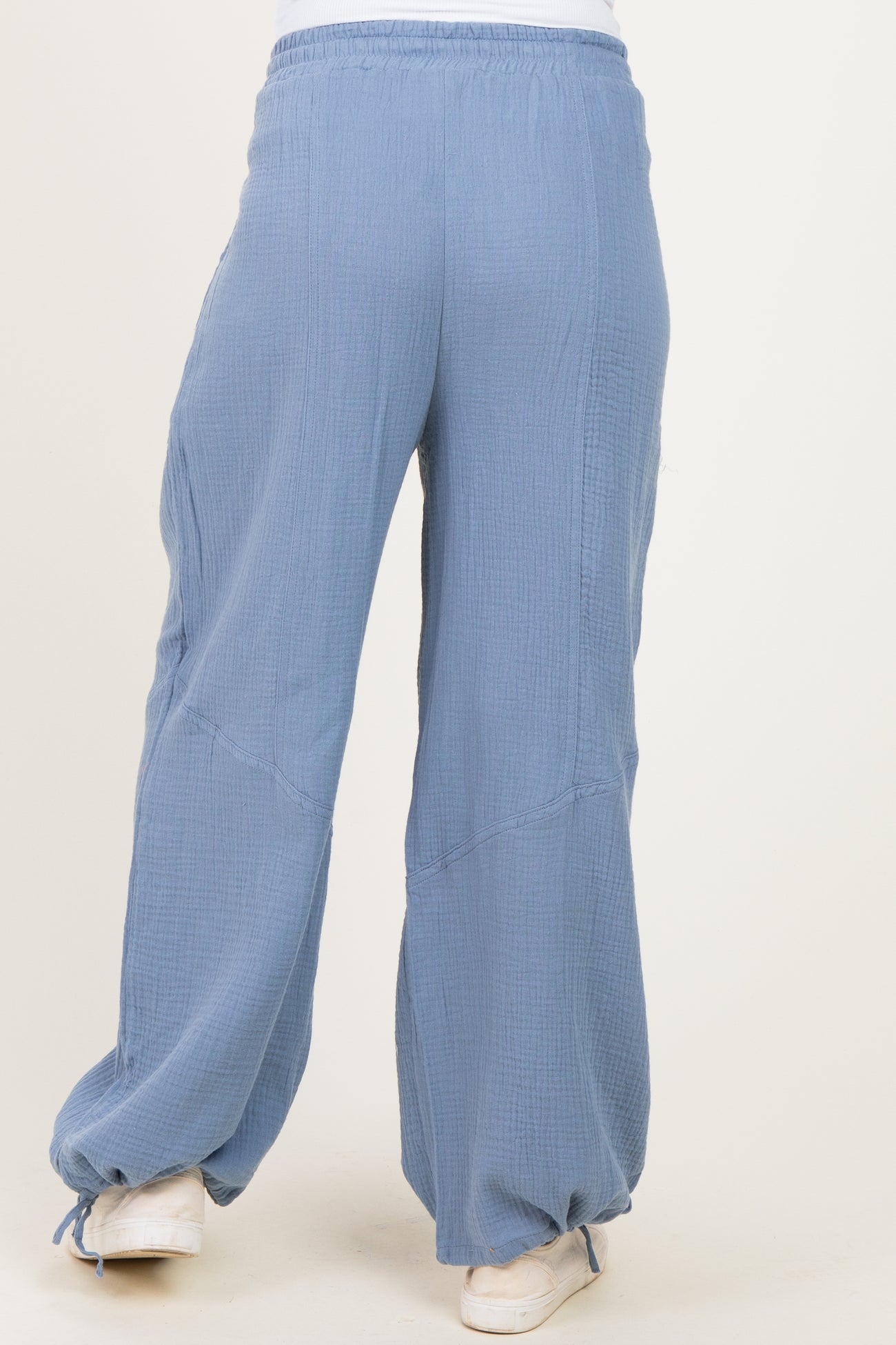 maternity wide leg pants in light blue with a textured finish and an elastic waistband, model seen from the back