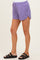 woman wearing purple maternity shorts with side slits and an elastic waistband