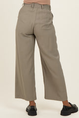 woman wearing light gray wide-leg maternity trousers with an elastic waistband and pockets, viewed from the back