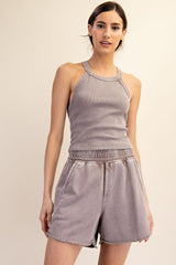 woman wearing a gray ribbed tank top and matching gray drawstring shorts
