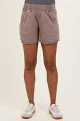 woman wearing light brown maternity shorts with an elastic waistband and side pockets