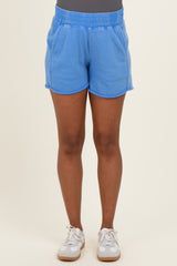 woman wearing light blue maternity shorts with an elastic waistband and side pockets