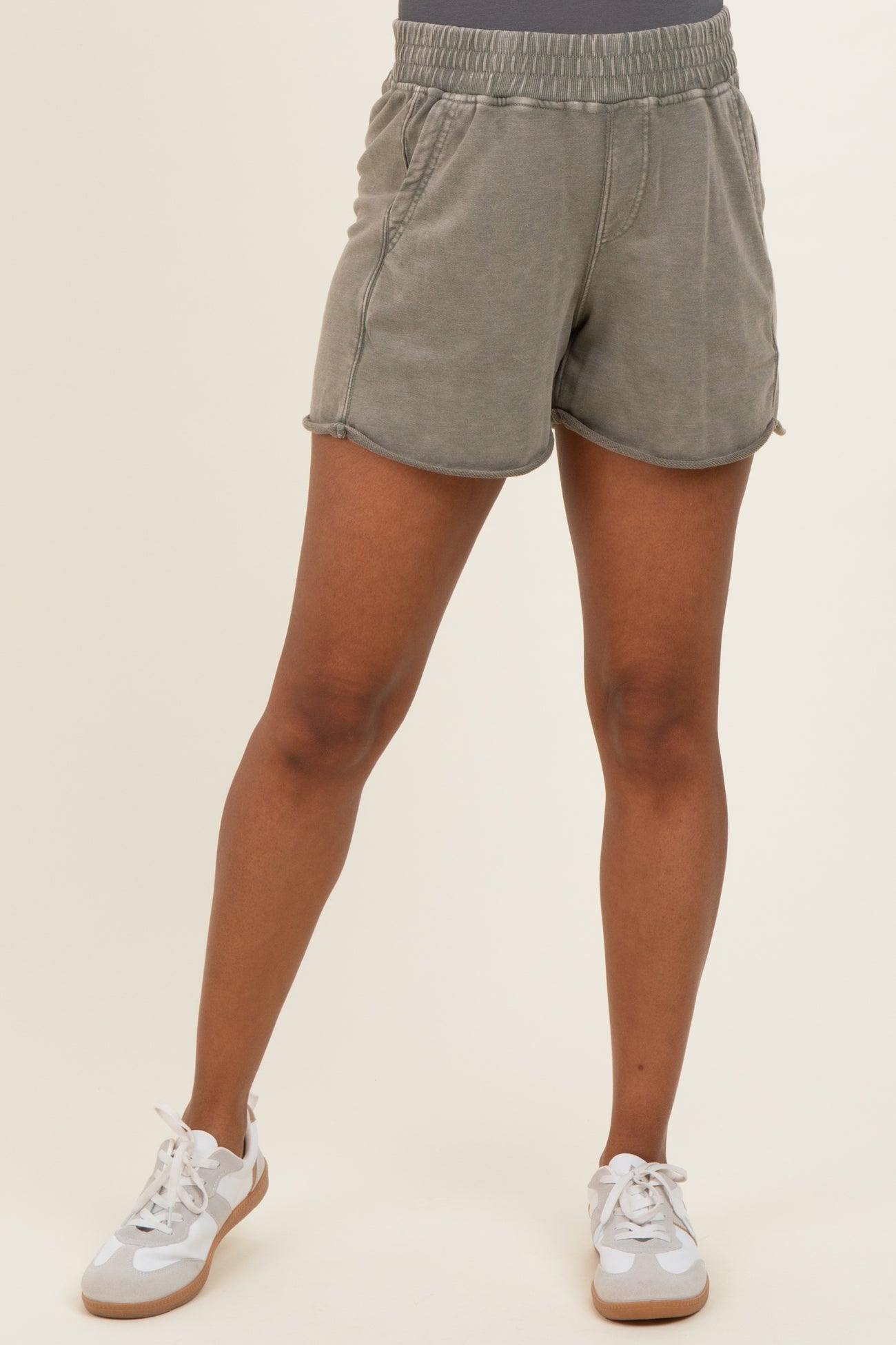 woman wearing light gray maternity shorts with an elastic waistband and a relaxed fit