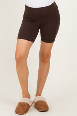 woman wearing brown maternity shorts with a high waistband and a smooth finish