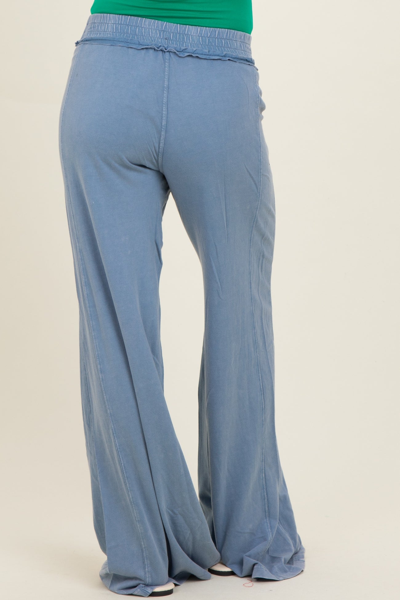 woman wearing lightweight blue maternity palazzo pants with an elastic waistband, showing the back view