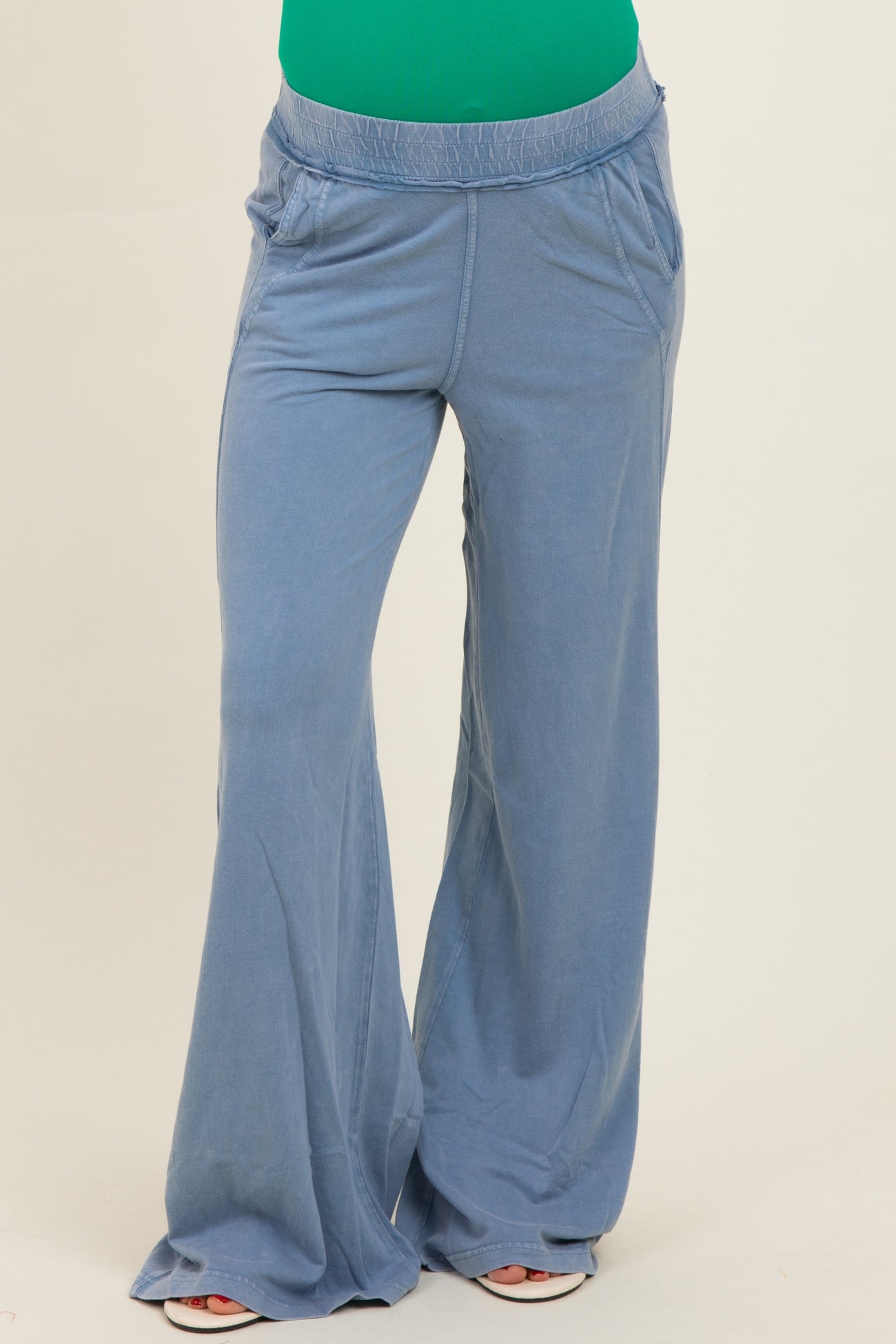 woman wearing light blue maternity wide-leg pants with pockets and an elastic waistband