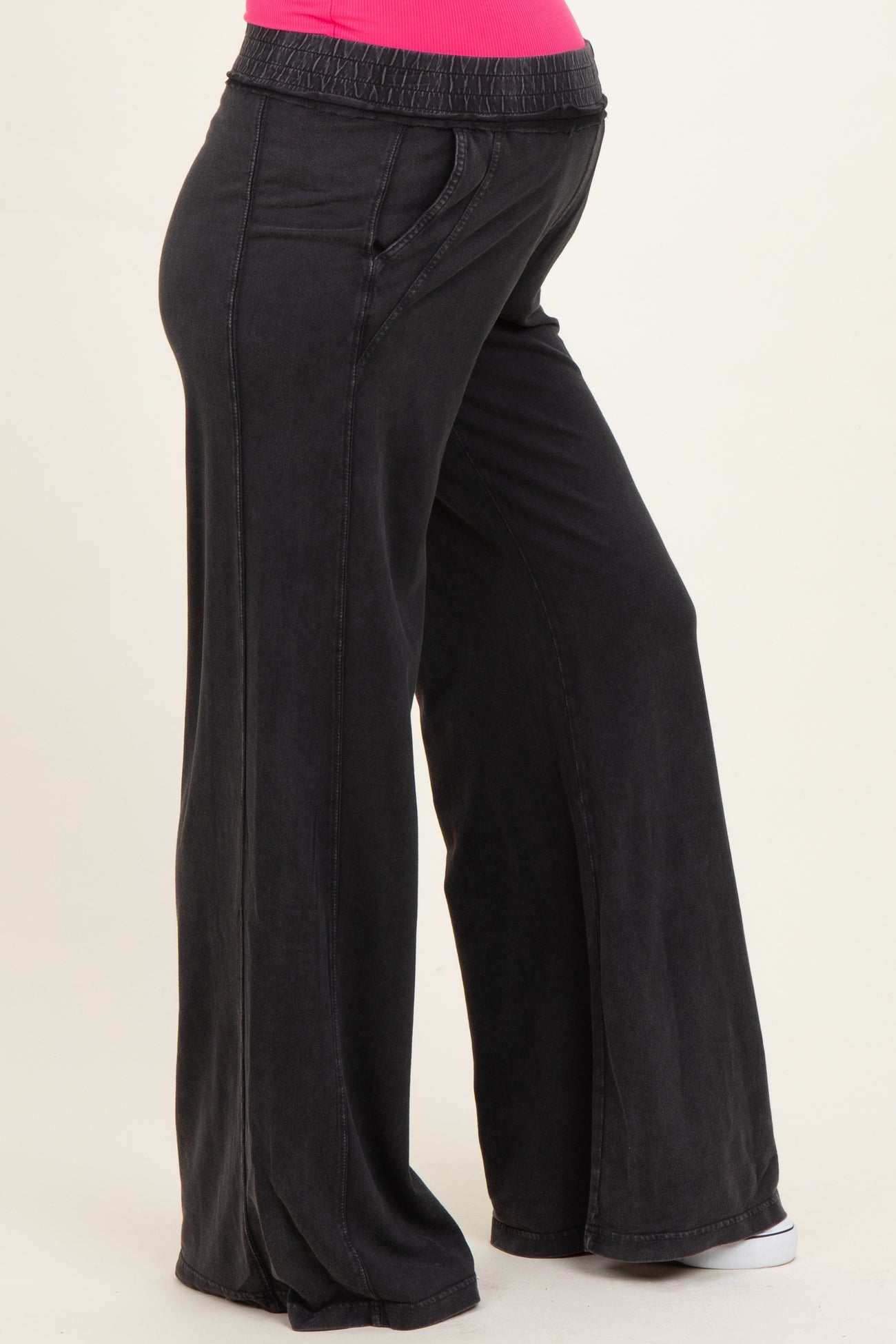 woman wearing black wide-leg maternity pants with an elastic waistband and pockets