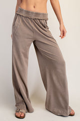 woman wearing taupe wide-leg lounge pants with an elastic waistband and side pockets