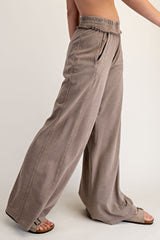 woman wearing taupe wide-leg pants with an elastic waistband and side pockets