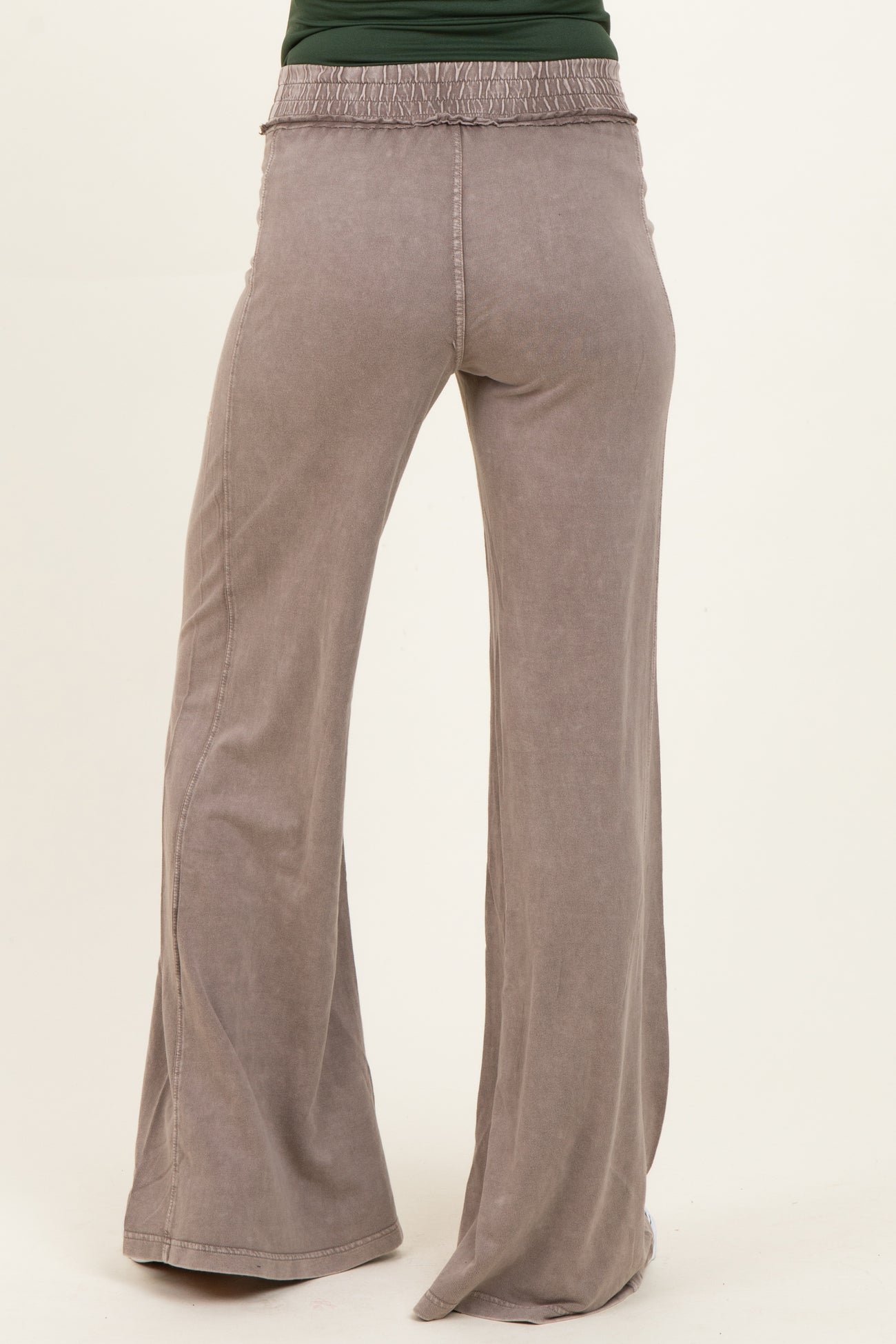 maternity wear light gray wide leg pants with smocked waist detail, model facing away from camera