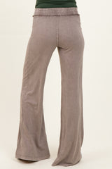 maternity wear light gray wide leg pants with smocked waist detail, model facing away from camera