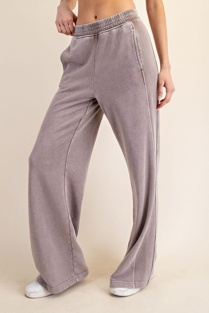woman wearing gray wide-leg lounge pants with an elastic waistband and side pockets