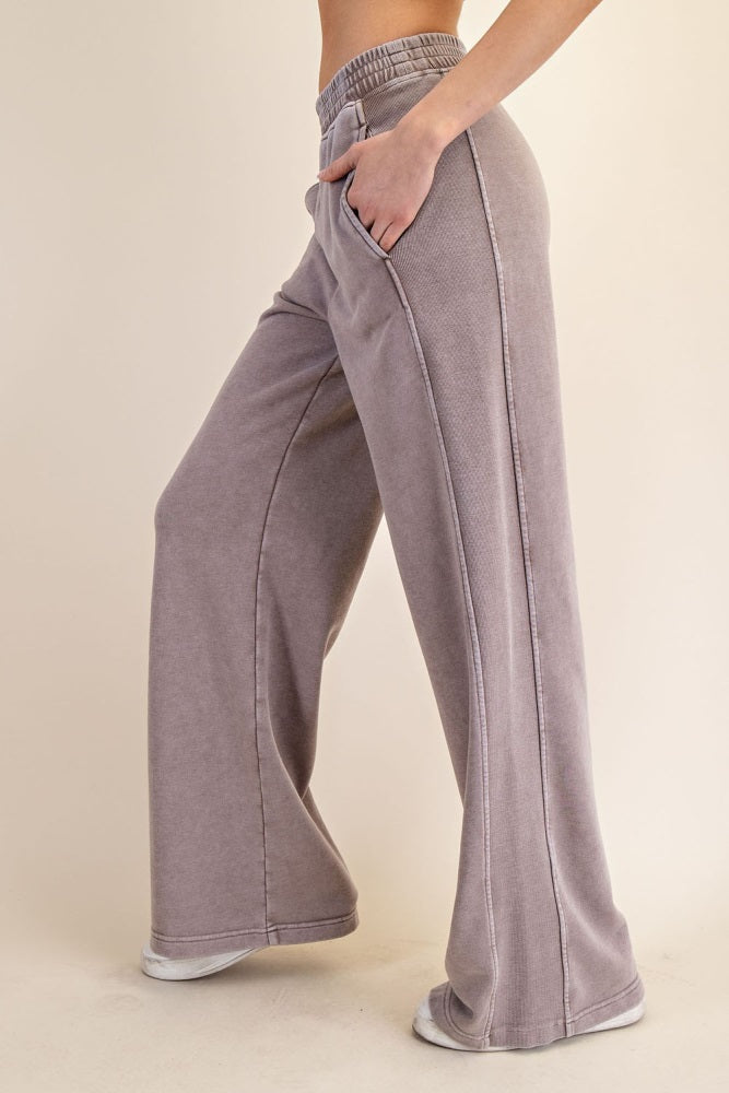 woman wearing gray wide-leg sweatpants with a drawstring waistband and side pockets
