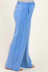 maternity wear, side view of a woman in light blue wide-leg pants with an elastic waistband and a visible baby bump