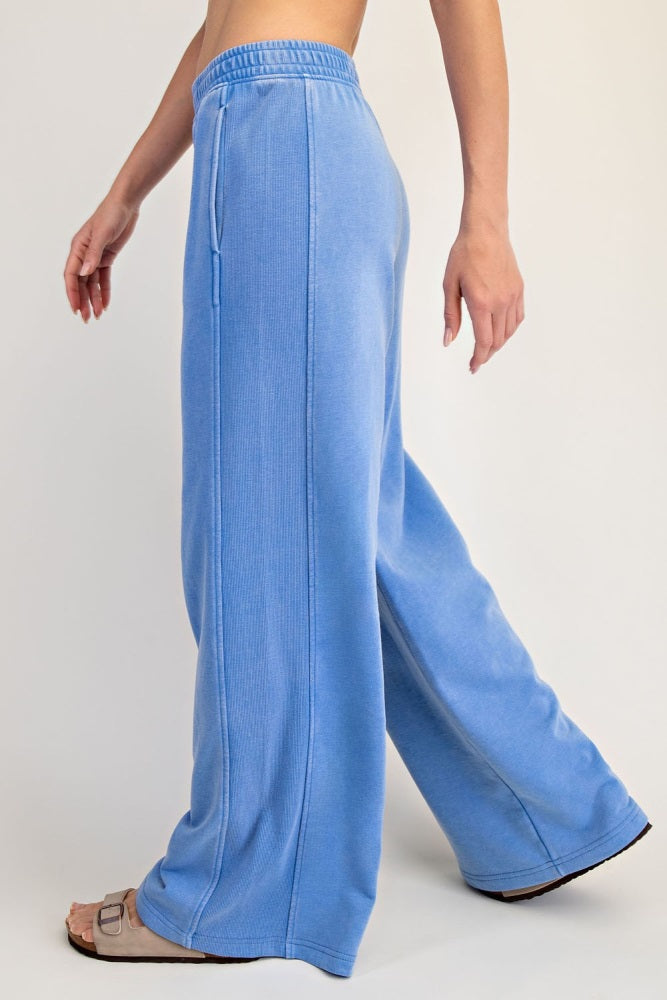 woman wearing light blue wide-leg lounge pants with an elastic waistband and side pockets