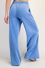 woman wearing light blue wide-leg lounge pants with a comfortable elastic waistband and side pockets