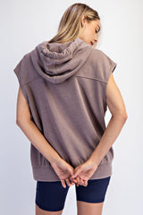 woman wearing a brown sleeveless hoodie from the back with a relaxed fit and hooded design
