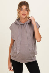 woman wearing a taupe sleeveless maternity hoodie with a kangaroo pocket and adjustable drawstrings