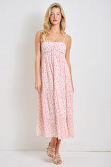 woman wearing a pink floral maxi dress with spaghetti straps and a tiered skirt