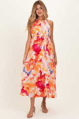 woman wearing a floral print maternity maxi dress in vibrant colors with a relaxed fit