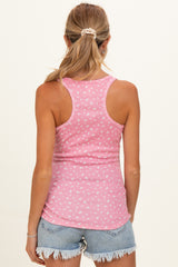 woman wearing a pink maternity tank top with a small heart print and styled with denim shorts