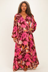 woman wearing a long purple floral plus-size maxi dress with long sleeves and a wrap style