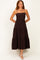 woman wearing a dark brown tiered maxi dress with spaghetti straps and a fitted bodice