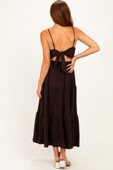 woman wearing a brown tiered maxi dress with a back tie detail and adjustable straps