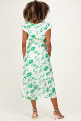 woman wearing a white maternity dress with green floral print and short sleeves, showing the back view