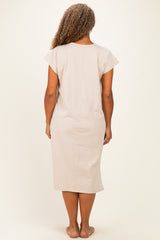 woman wearing a beige short sleeve plus size dress, viewed from the back