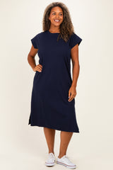 woman wearing a navy blue short sleeve midi dress with side slits and a relaxed fit