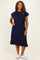 woman wearing a navy blue short sleeve midi dress with side slits and a relaxed fit