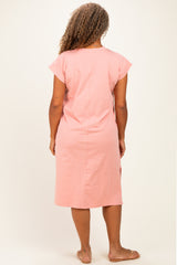 woman wearing a pink short sleeve plus size dress with a relaxed fit, view of the back