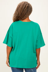 woman wearing a green oversized short sleeve t-shirt, view from the back