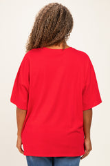 woman wearing a loose-fitting red oversized t-shirt viewed from the back