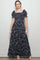 woman wearing a black floral maxi dress with short puff sleeves and a square neckline