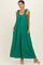 woman wearing a green sleeveless maxi dress with ruffled straps and pockets